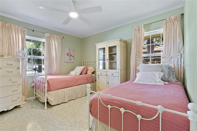 bedroom featuring a ceiling fan, ornamental molding, and speckled floor