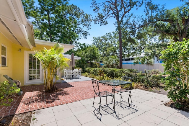 view of patio / terrace featuring fence and outdoor dining area