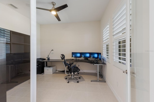 tiled home office featuring ceiling fan, visible vents, and baseboards