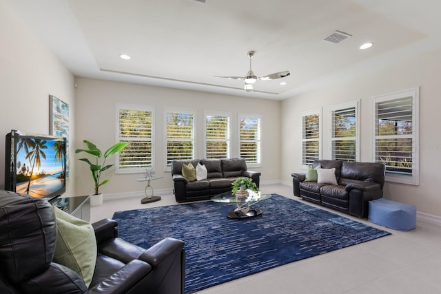 tiled living area with a ceiling fan, recessed lighting, visible vents, and baseboards