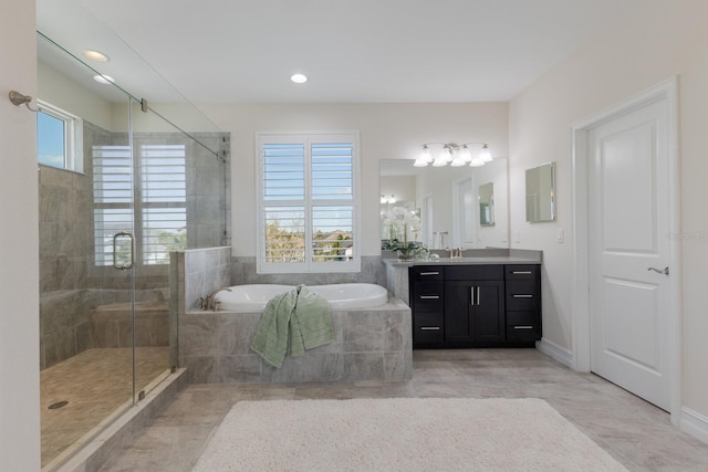 full bathroom featuring plenty of natural light, vanity, a bath, and a shower stall