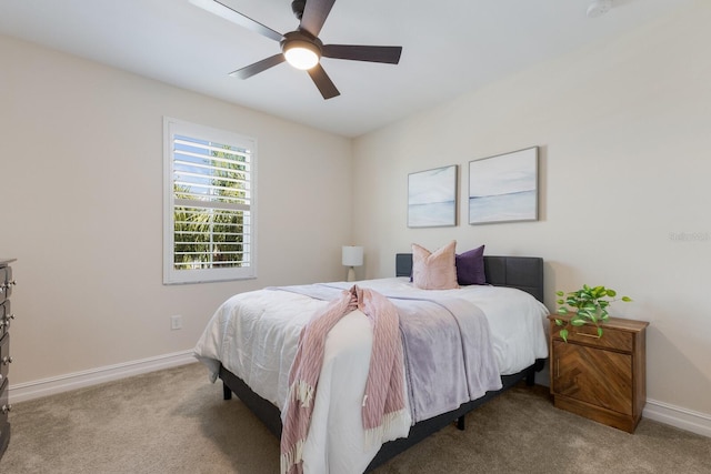 carpeted bedroom featuring a ceiling fan and baseboards