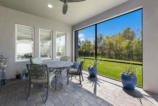 sunroom featuring a ceiling fan