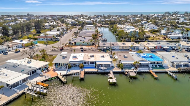 drone / aerial view with a water view and a residential view