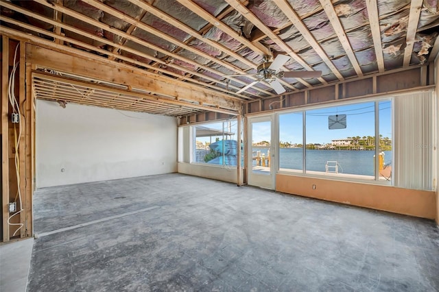 interior space with a water view and a ceiling fan