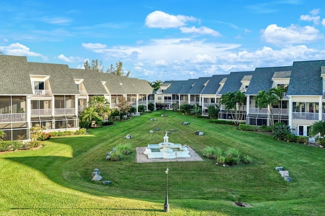 view of community featuring a lawn and a residential view