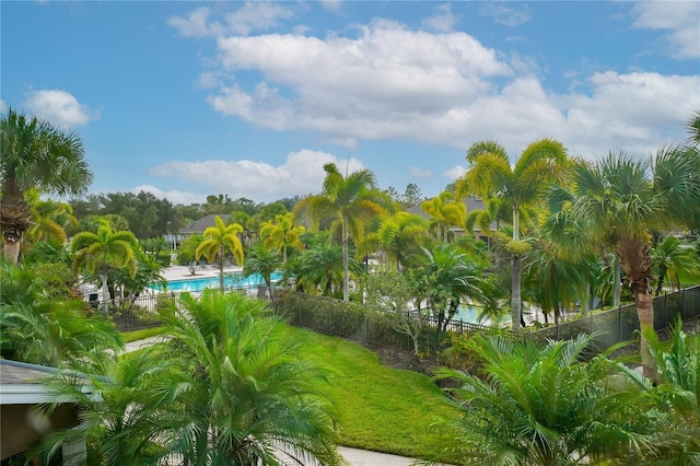 surrounding community with a swimming pool and fence