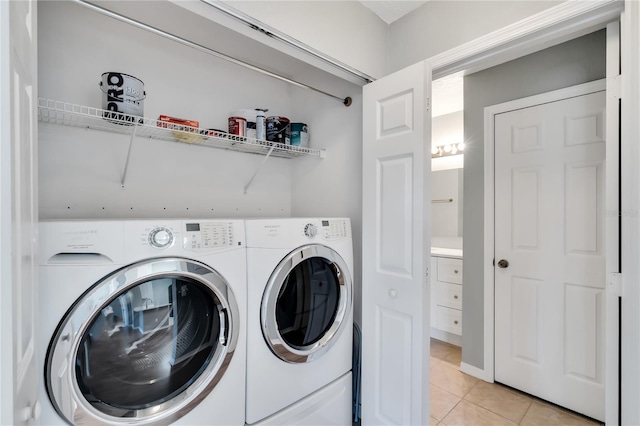 washroom with light tile patterned floors, laundry area, and independent washer and dryer