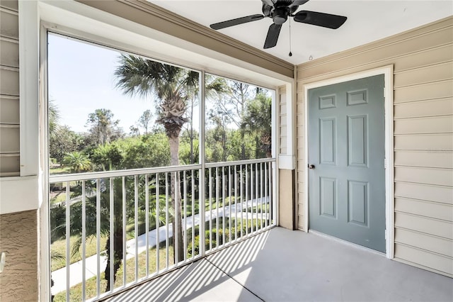 sunroom featuring a ceiling fan