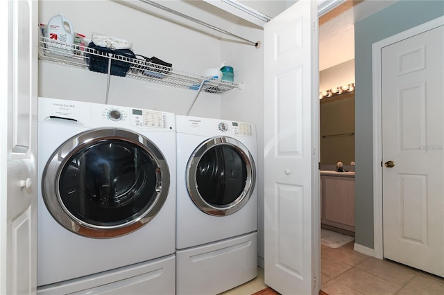 laundry room with laundry area, light tile patterned floors, and independent washer and dryer