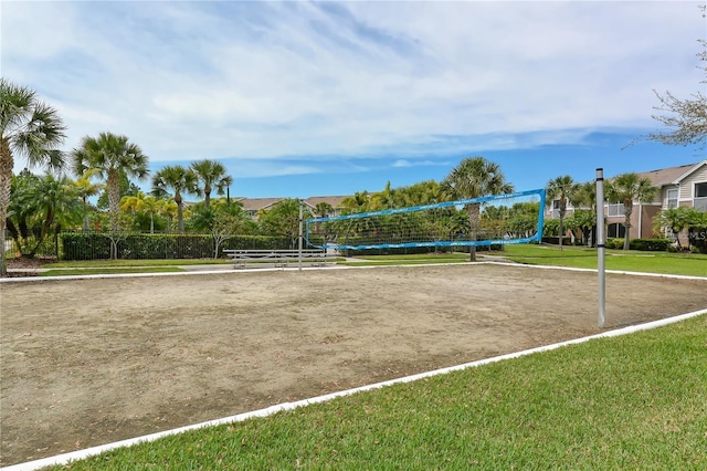 surrounding community with a lawn and volleyball court