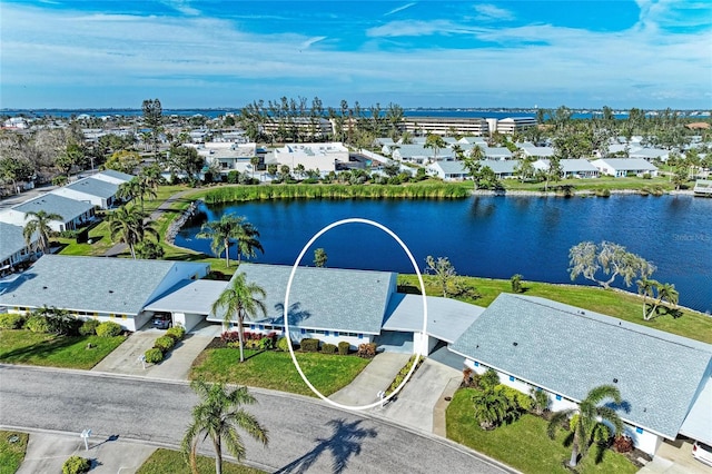 drone / aerial view featuring a water view and a residential view