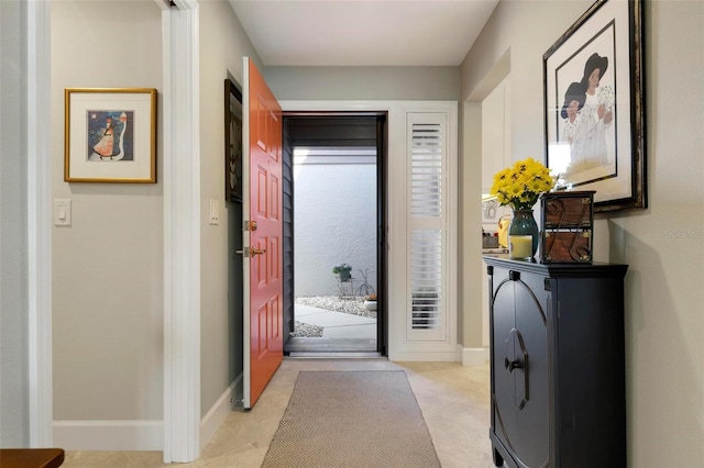 doorway featuring baseboards