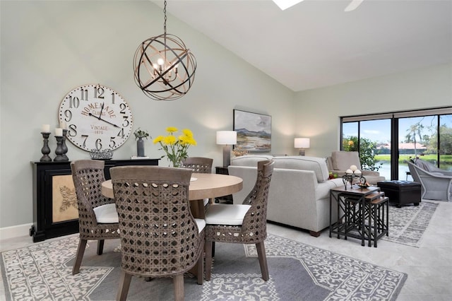 dining area featuring high vaulted ceiling, baseboards, and an inviting chandelier