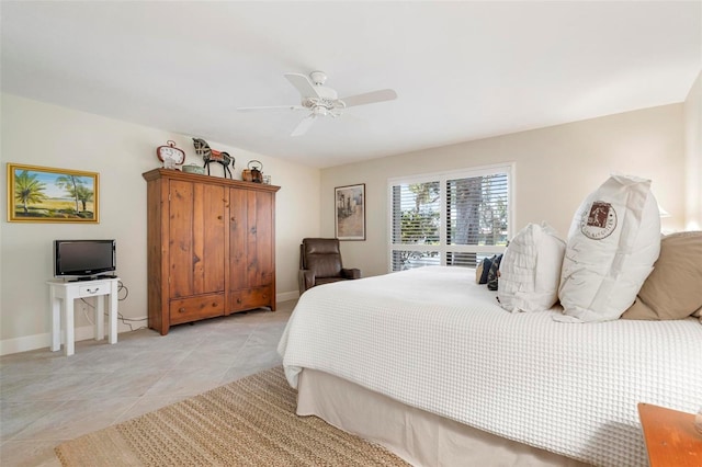 bedroom featuring a ceiling fan, light tile patterned flooring, and baseboards