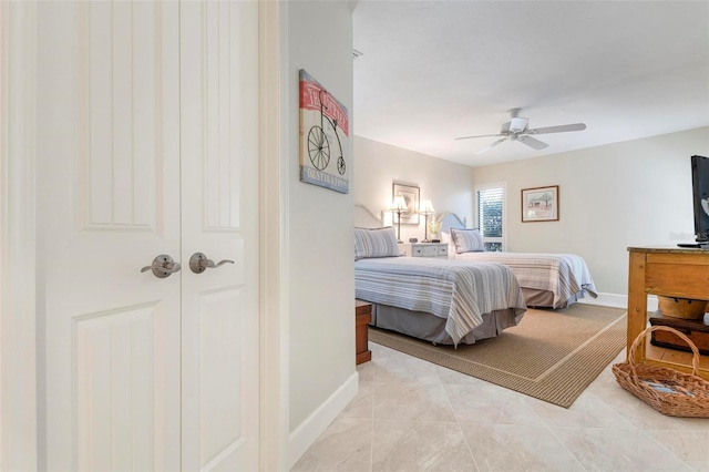 bedroom featuring ceiling fan, baseboards, and light tile patterned floors