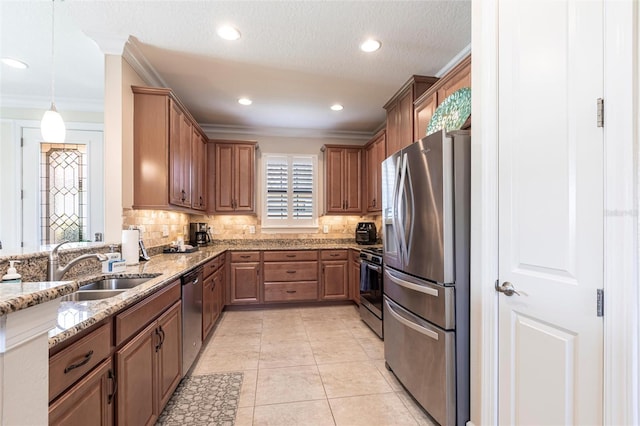 kitchen with appliances with stainless steel finishes, tasteful backsplash, light stone counters, and light tile patterned floors