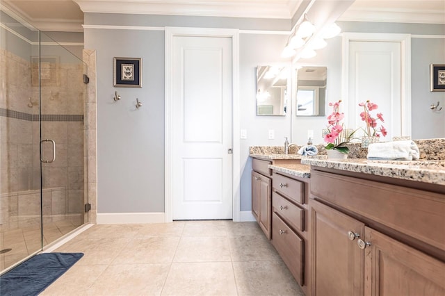 bathroom featuring a stall shower, tile patterned flooring, crown molding, and vanity