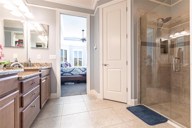 ensuite bathroom with a shower stall, vanity, ornamental molding, and tile patterned floors