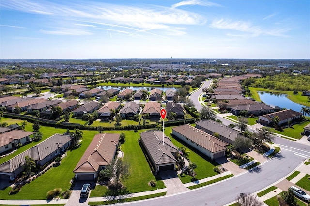 drone / aerial view with a water view and a residential view