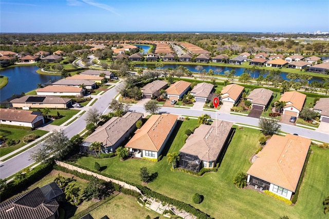 birds eye view of property with a water view and a residential view