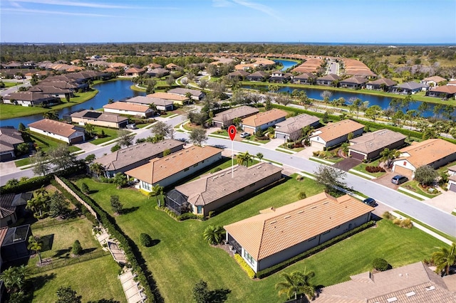 drone / aerial view featuring a water view and a residential view