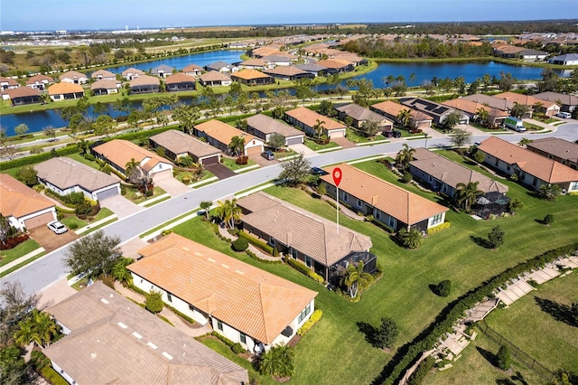 drone / aerial view featuring a water view and a residential view