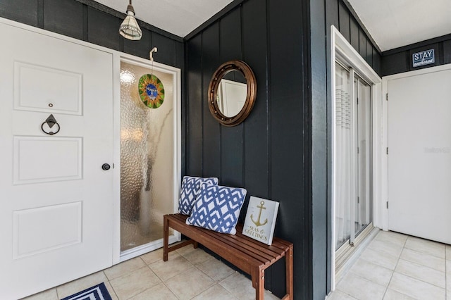 interior space featuring light tile patterned floors and a decorative wall