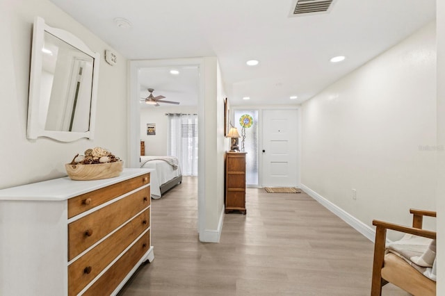 interior space with baseboards, recessed lighting, visible vents, and light wood-style floors