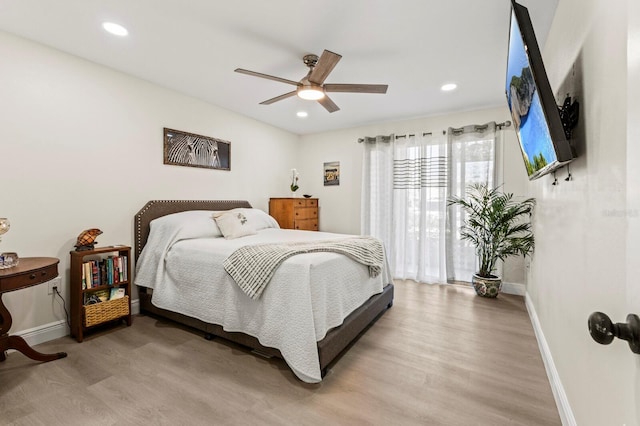 bedroom with a ceiling fan, recessed lighting, light wood-style flooring, and baseboards