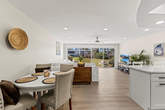 dining area with a ceiling fan, recessed lighting, and light wood-style flooring