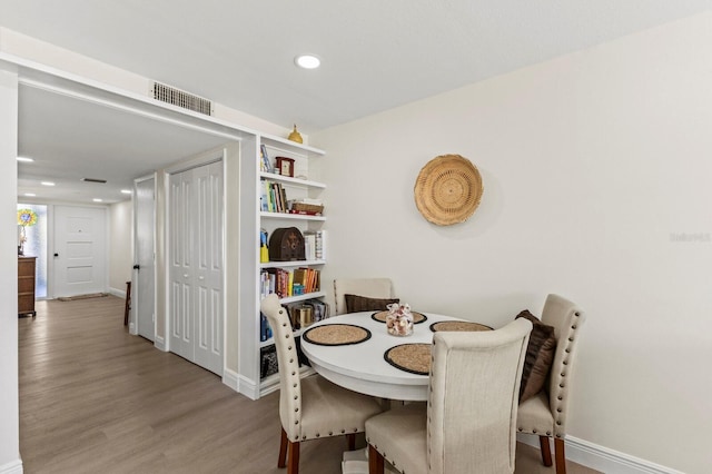 dining area featuring recessed lighting, visible vents, baseboards, and wood finished floors