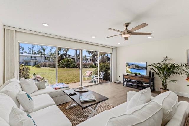 living room with a ceiling fan, recessed lighting, a healthy amount of sunlight, and wood finished floors