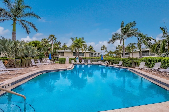 pool featuring fence and a patio