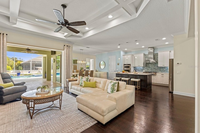 living area with baseboards, dark wood-type flooring, a textured ceiling, and crown molding