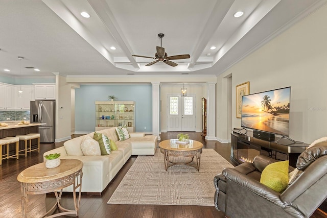 living area with baseboards, dark wood-style flooring, beam ceiling, and ornate columns