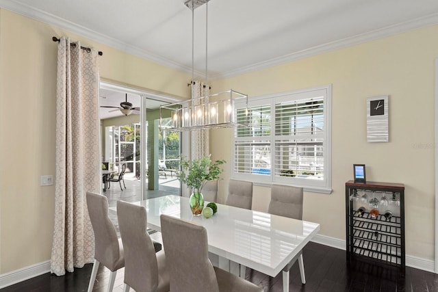 dining room featuring ceiling fan with notable chandelier, baseboards, crown molding, and wood finished floors