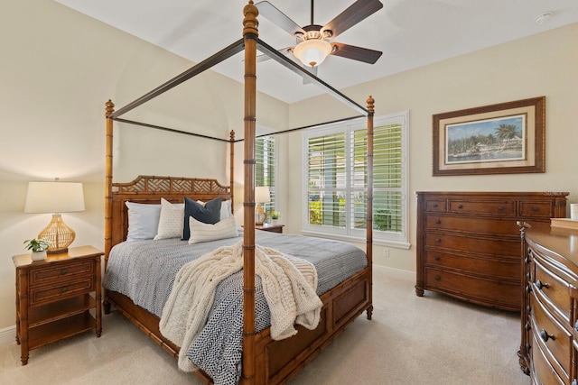 bedroom with baseboards, ceiling fan, and light colored carpet