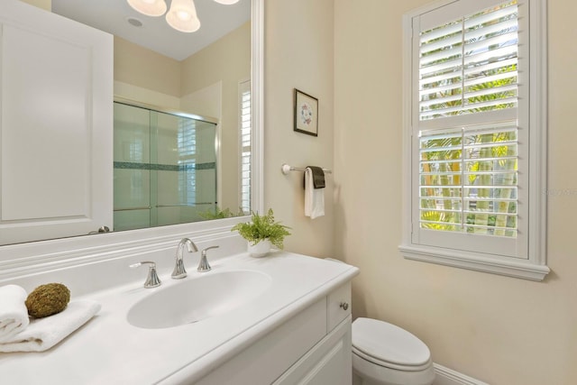 full bathroom with toilet, a shower stall, and vanity