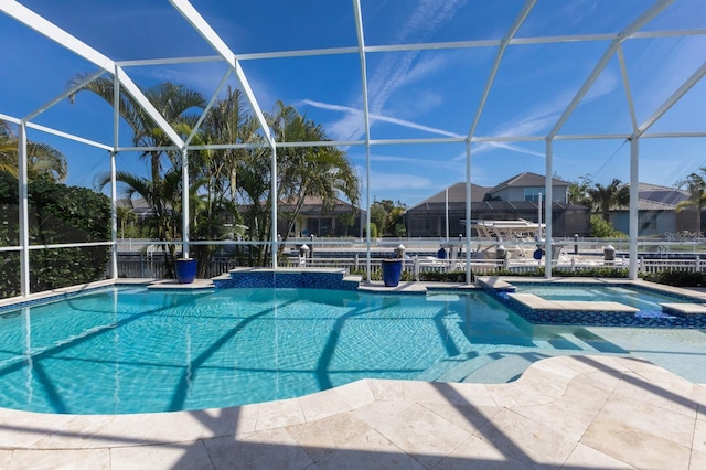 view of pool featuring a patio, a lanai, and a pool with connected hot tub