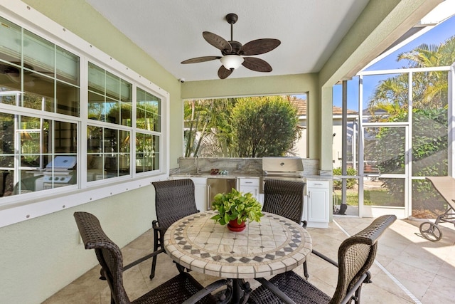 sunroom with ceiling fan and a healthy amount of sunlight