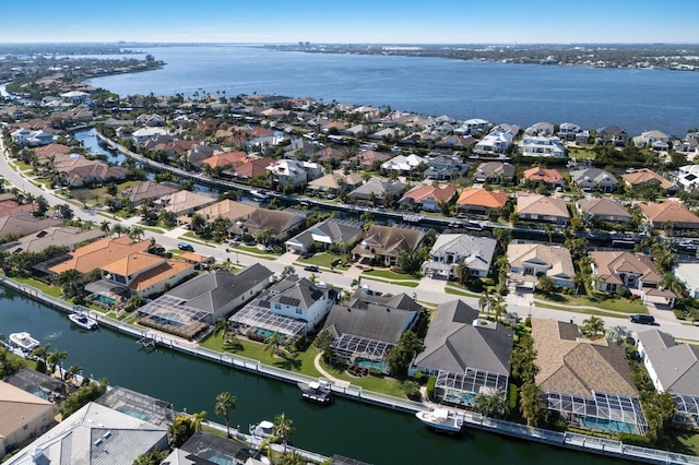 birds eye view of property with a water view and a residential view