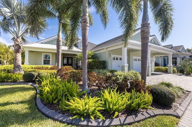 view of front of property with an attached garage and decorative driveway