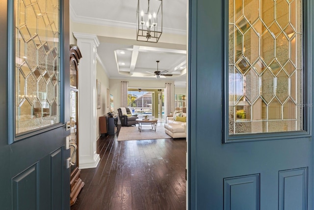 foyer entrance with dark wood-style floors, ceiling fan, ornamental molding, and coffered ceiling