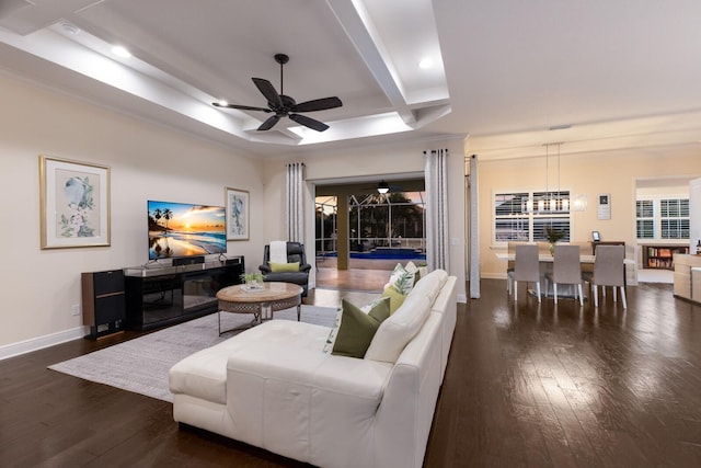 living room featuring ceiling fan, recessed lighting, hardwood / wood-style floors, baseboards, and a tray ceiling