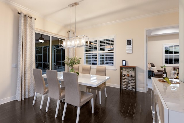 dining area featuring dark wood-style floors, baseboards, a chandelier, and crown molding