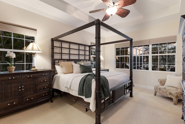 bedroom with a ceiling fan, light colored carpet, crown molding, and baseboards