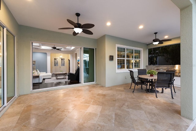 view of patio featuring outdoor dining area and a ceiling fan