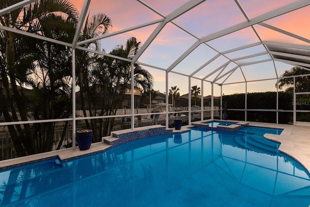 view of swimming pool with a lanai, a patio area, and a pool with connected hot tub