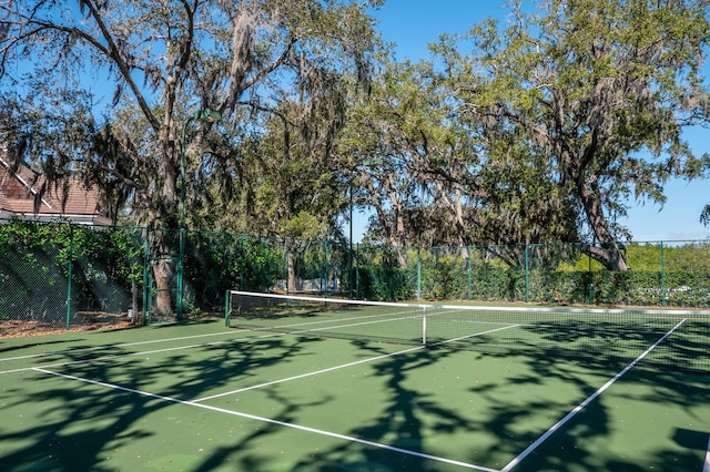 view of tennis court featuring fence